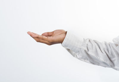 Close-up of human hand against white background