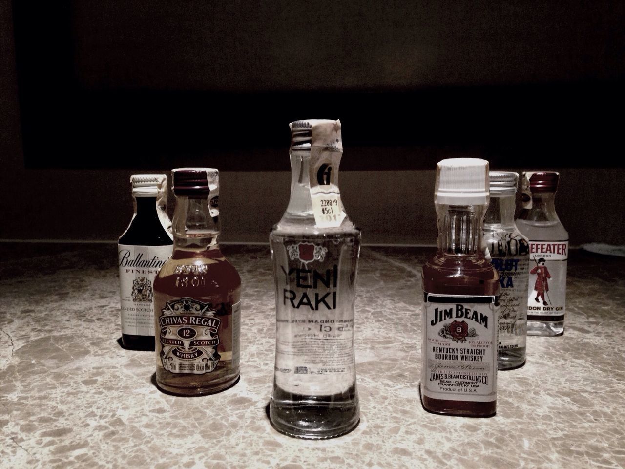 indoors, text, table, still life, western script, communication, close-up, drink, glass - material, bottle, no people, focus on foreground, jar, food and drink, variation, home interior, number, technology, container, refreshment