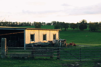 Abandoned house on field against sky