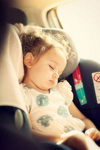 Cute girl sleeping in car