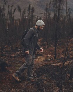 Man standing on field in forest