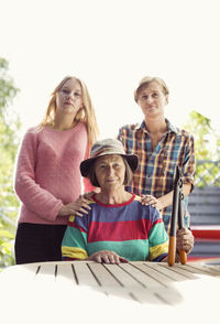 Portrait of three generation females in yard