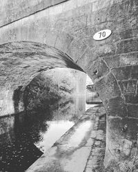 Road sign by wall in tunnel