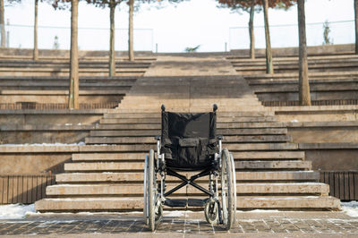 Rear view of man walking on staircase