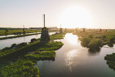 Bridge over river against sky during sunset