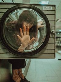 Reflection of woman on mirror in glass