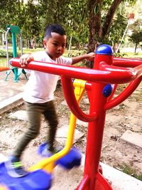 Boy playing on slide at playground