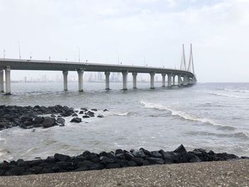 Bridge over sea against sky