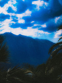 Scenic view of mountains against blue sky