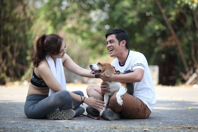 Man and dog sitting outdoors