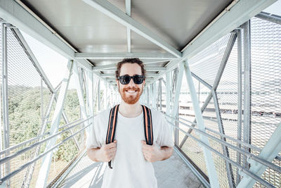 Portrait of man stranding on bridge