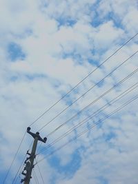 Low angle view of electricity pylon against sky