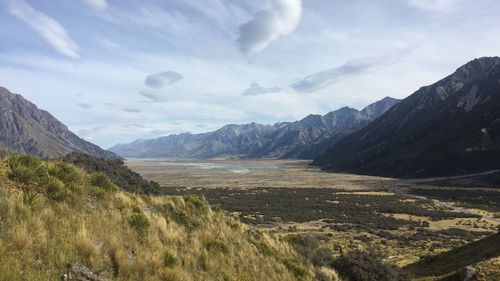 Scenic view of mountains against cloudy sky