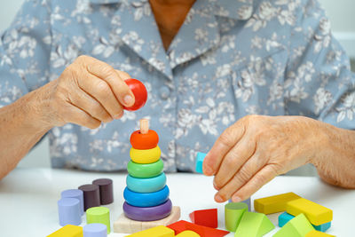 Midsection of man playing with toy blocks