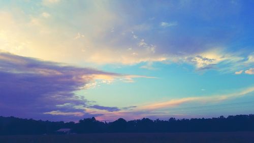 Silhouette trees against sky during sunset