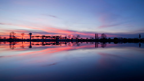 Scenic view of lake against sky during sunset