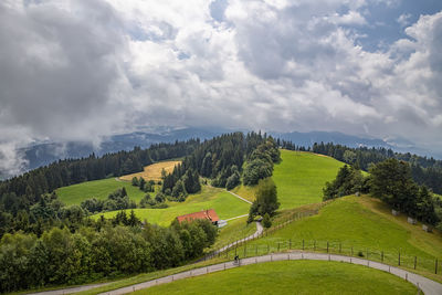 Amazing idyllic landscape with green rolling hills, road, and farmhouses in the mountain of austria