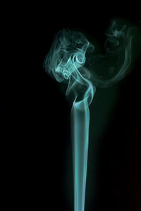 Close-up of smoke emitting from black background