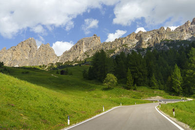 Panoramic shot of road by mountains against sky