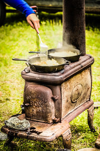 Cropped hand preparing food in yard