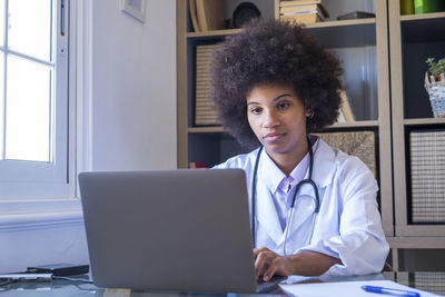 Doctor working on laptop in clinic