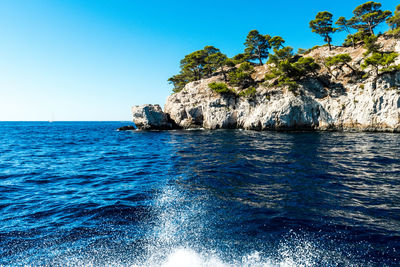 Scenic view of sea against clear blue sky