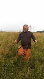 Full length of man on field against clear sky