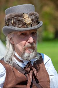 Portrait of bearded mature man wearing hat outdoors