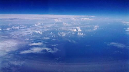 Aerial view of landscape against blue sky