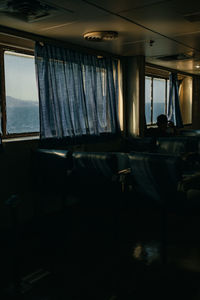 Empty chairs and tables in window