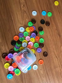 High angle view of multi colored buttons on table