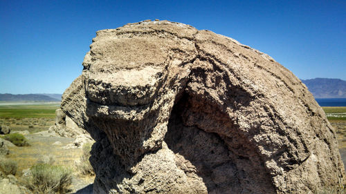 Close-up of mountain against blue sky