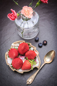 High angle view of strawberries in bowl on table