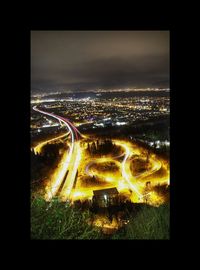 High angle view of illuminated city buildings at night