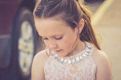 Close-up of cute girl looking down