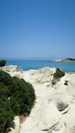 Scenic view of beach against clear blue sky