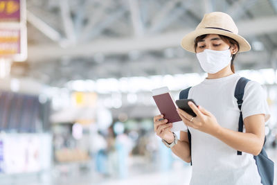 Beautiful woman with mask in airport