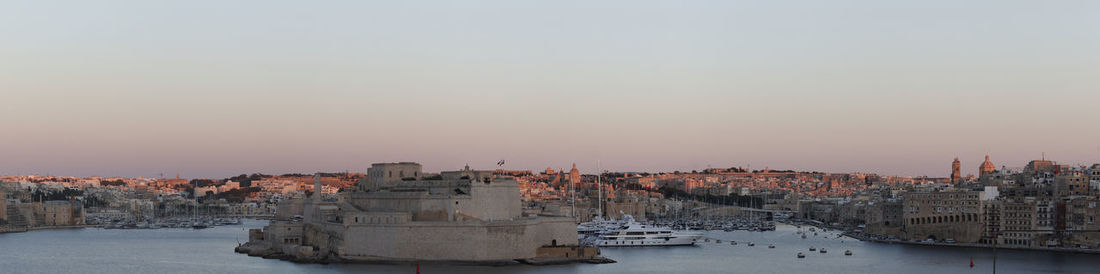 Panoramic view of buildings against sky during sunset