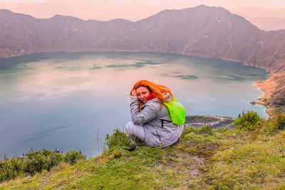 Portrait of young woman in lake during winter