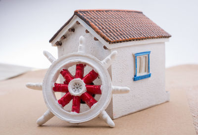 Close-up of model home and wheel on table