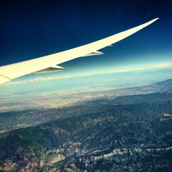 Cropped image of airplane flying over landscape