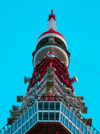 Low angle view of tokyo tower against clear blue sky