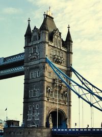 Low angle view of bridge against cloudy sky