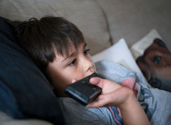 High angle view of boy using mobile phone