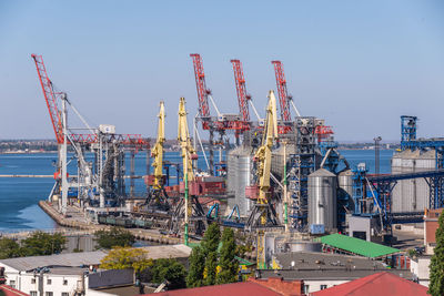 Harbor cranes in the cargo port and container terminal in odessa, ukraine, on a sunny day