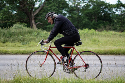 Man riding bicycle on tree