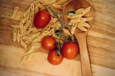 High angle view of tomatoes and pasta  on cutting board