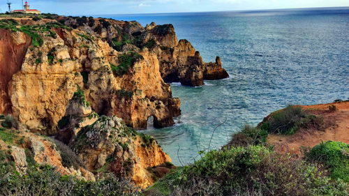 High angle view of rock formations by sea