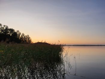 Scenic view of lake against sky during sunset