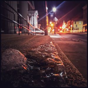 Close-up of illuminated city street at night